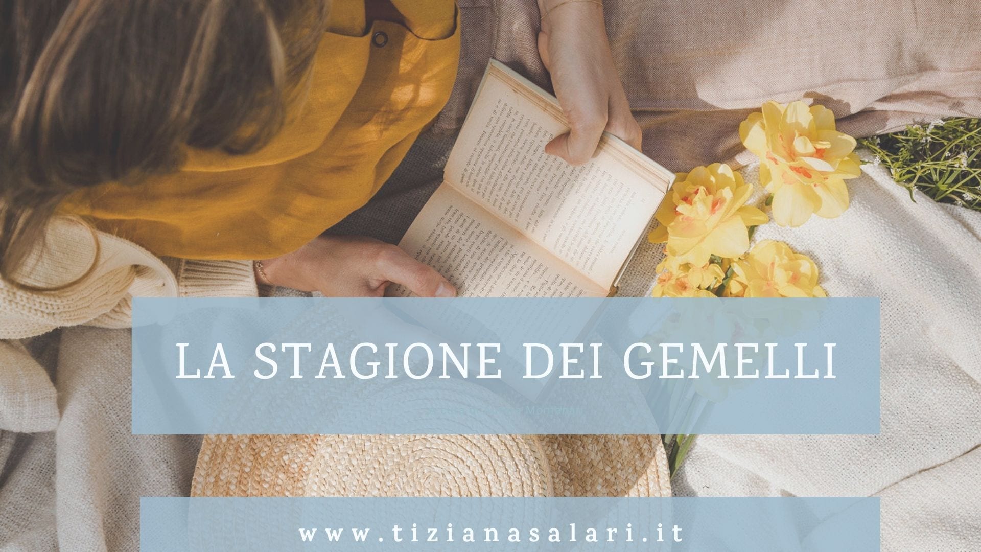 donna distesa su un prato fiorito che legge un libro